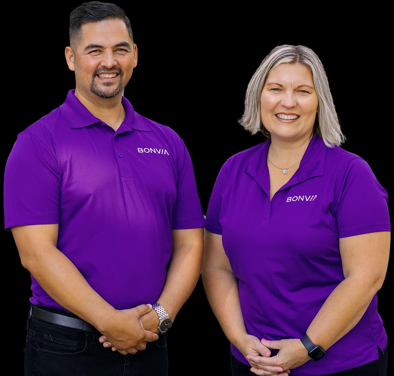 Two Bonvia drivers in branded purple polos, standing together.